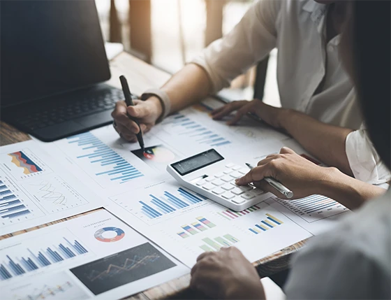 A professional team in a UAE office collaborating with their research partner to discuss market insights and corporate strategy.