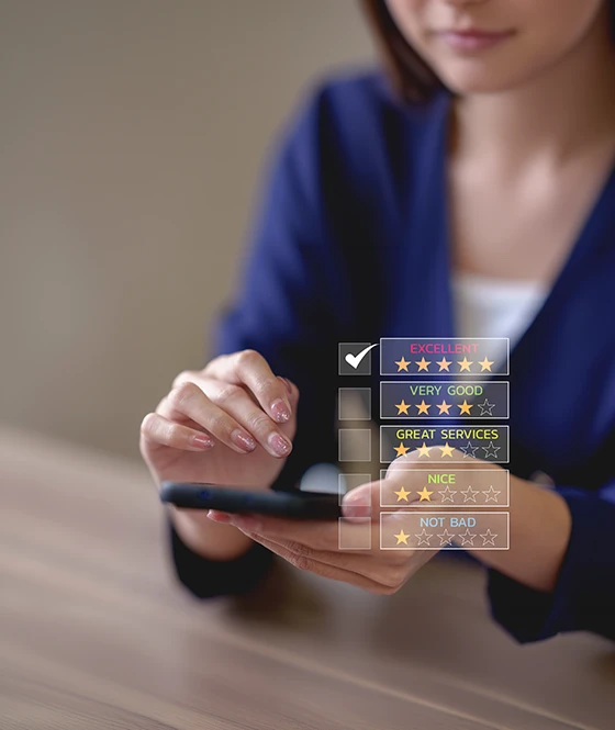 A woman holding a smartphone and selecting an excellent 5-star rating on a digital review interface for telephone surveys.