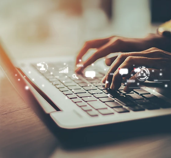 Person typing on a laptop while participating in Market Research Online Communities in the UAE through digital engagement.