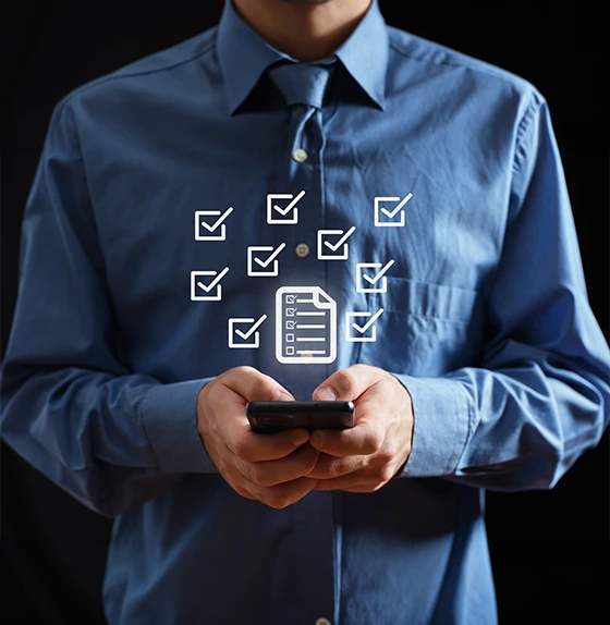 A man in a blue shirt holding a smartphone with digital checklist and checkmark icons floating above, representing digital telephone surveys and feedback collection.
