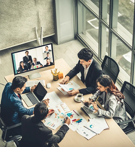 Online Focus Group Interviews with business professionals participating in a hybrid virtual meeting and analysing research data in a modern office.