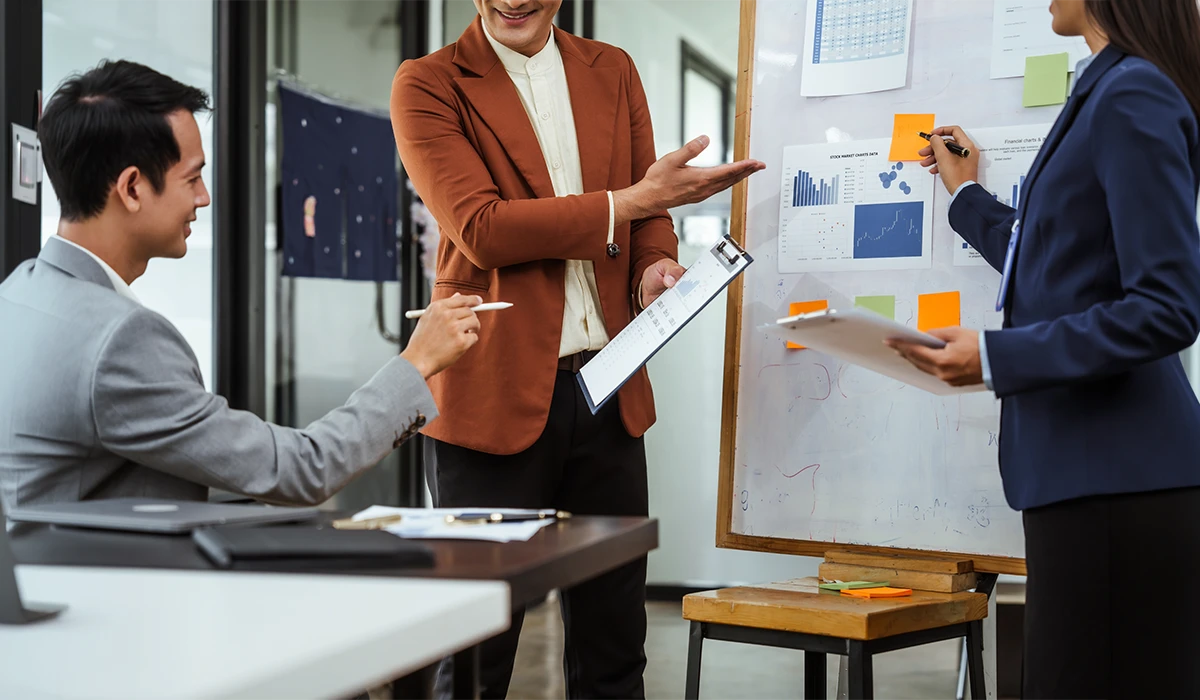 Business professionals discussing charts during a Large Scale Data Analysis meeting